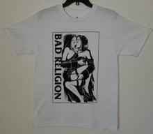 Load image into Gallery viewer, A white t-shirt featuring the &quot;Nuns Kissing&quot; graphic from the punk rock band Bad Religion. The bold design captures the rebellious spirit of the band, showcasing iconic imagery. Made from 100% cotton for a soft, breathable feel, this shirt is available in unisex sizes from Small to 2XL, perfect for punk rock enthusiasts and those who appreciate edgy, statement-making fashion.
