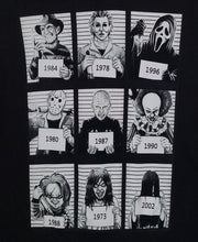 Load image into Gallery viewer, &quot;9 Most Wanted Mugshots&quot; Horror Unisex T-Shirt featuring black and white mugshots of iconic horror characters: Freddy Krueger, Michael Myers, Ghostface, Jason Voorhees, Pinhead, Pennywise, Chucky, Regan from The Exorcist, and Samara from The Ring. Each character is labeled with their debut year.







